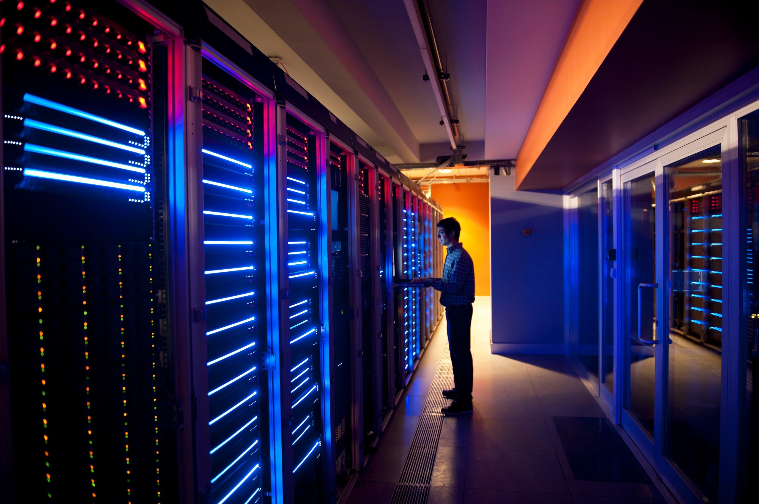 Engineer working in a server room representing project coordination