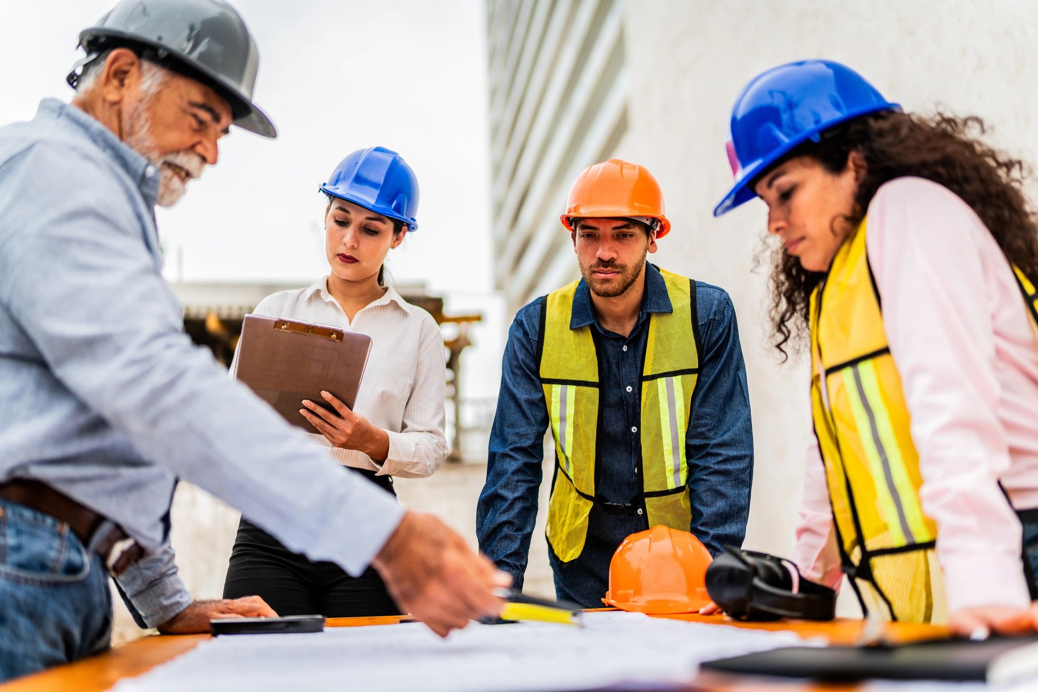 Project team reviewing blueprints on a job site