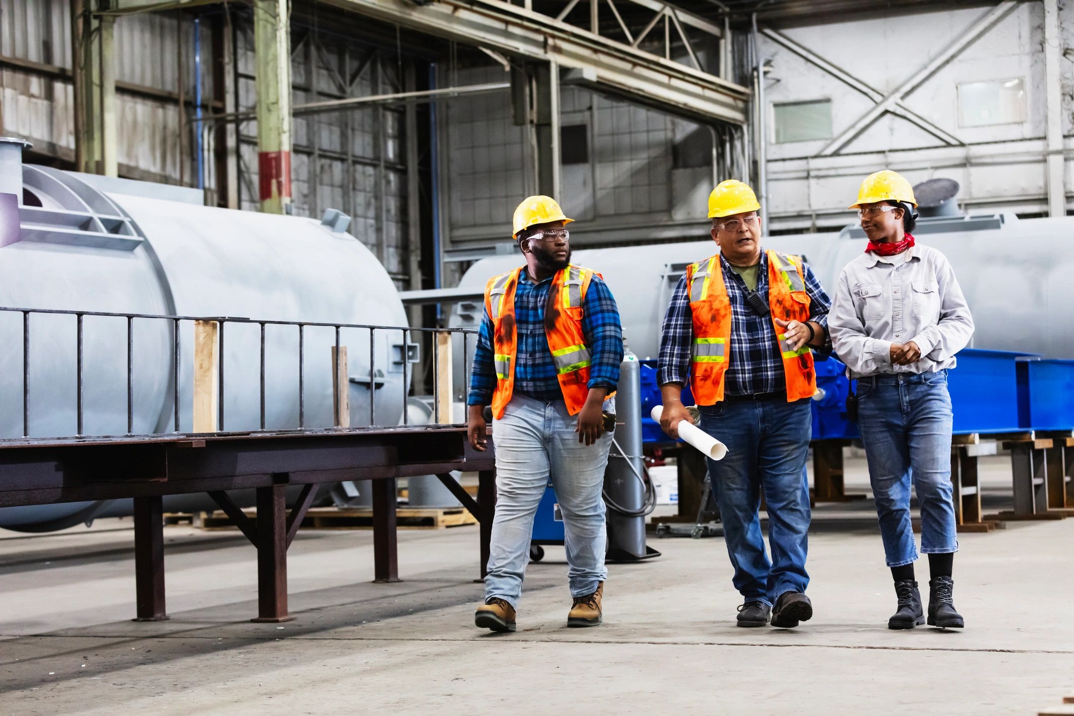 Engineering team walking through an industrial facility discussing plans