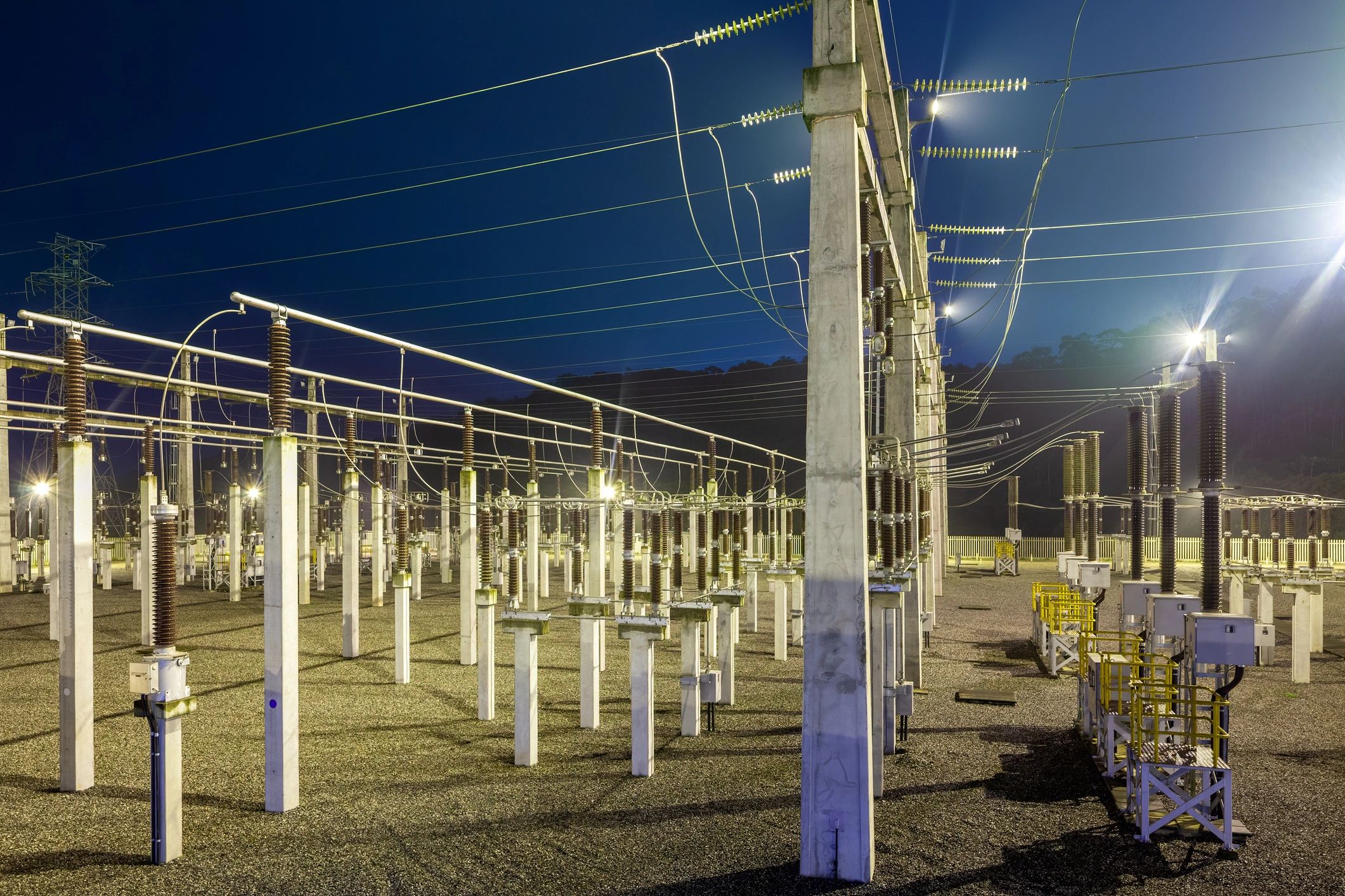 Nighttime view of a high-voltage electrical substation